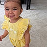 toddler, child, smiling, yellow_dress, sandals, hair_clips, indoor, floor_tiles, kitchen, table, chairs, cute, happy, person, fashion, young_child, standing, accessories, playful, portrait