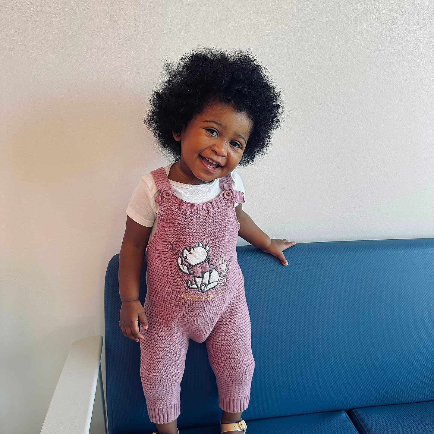 Rhylei joined the competition — help win amazing prizes! baby, babylaughing, blackhair, child, clothing, curlyhair, face, female, girl, hair, happy, head, pants, person, photography, portrait, sitting, sleeve, smile, standing