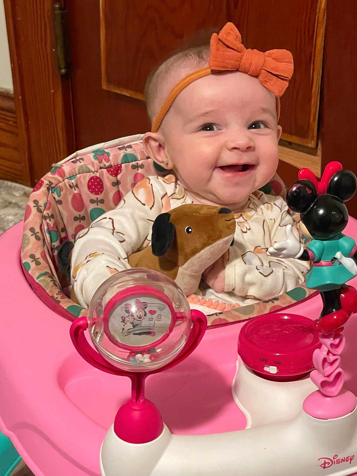 Zayley joined the competition — help win amazing prizes! baby, child, smiling, headband, bow, plush_toy, dog_toy, baby_walker, pink, minnie_mouse, toy, happy, indoor, wooden_cabinet, person, infant, clothing, face, sitting, cute