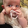 Zayley is registered to the contest to win money with this photo: baby, pacifier, headband, flower, dress, infant, hand, face, skin, clothing, cute, child, person, portrait, indoor, closeup, expression, adorable, young, pink