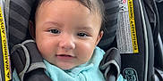Alejando Noriega is registered to the contest to win money with this photo: baby, child, car_seat, graco, seatbelt, turquoise_clothing, curly_hair, smile, infant, safety_harness, portrait, indoors, vehicle, window, straps, warning_label, cute, young_child, person, closeup