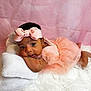 baby, infant, girl, headband, bow, pink_dress, tulle, pillow, white_rug, soft_texture, portrait, cute, resting, curious, indoor, child, smiling, pink_background, closeup, adorable