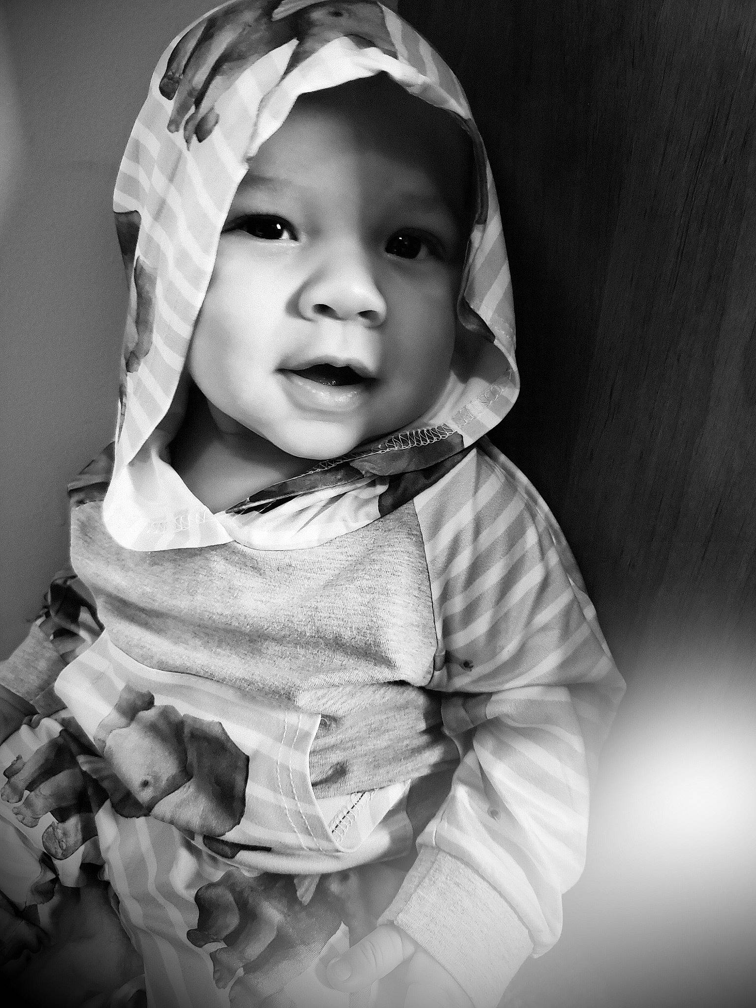 Gabryel is registered to the contest to win money with this photo: baby, black, black_and_white, cheek, child, eye, face, facial_expression, head, monochrome, monochrome_photography, outerwear, people, person, photograph, photography, skin, smile, snapshot, toddler