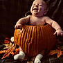 baby, pumpkin, fall, autumn_leaves, smiling, cute, infant, sock, holiday, seasonal, happy, celebration, child, orange, nature, fun, cozy, cute_expression, festive, warm