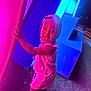 child, toddler, hood, smile, barefoot, neon_lights, pink_light, blue_light, night, glowing, curious, standing, outdoor, playful, colorful, person, clothing, texture, joyful, illumination