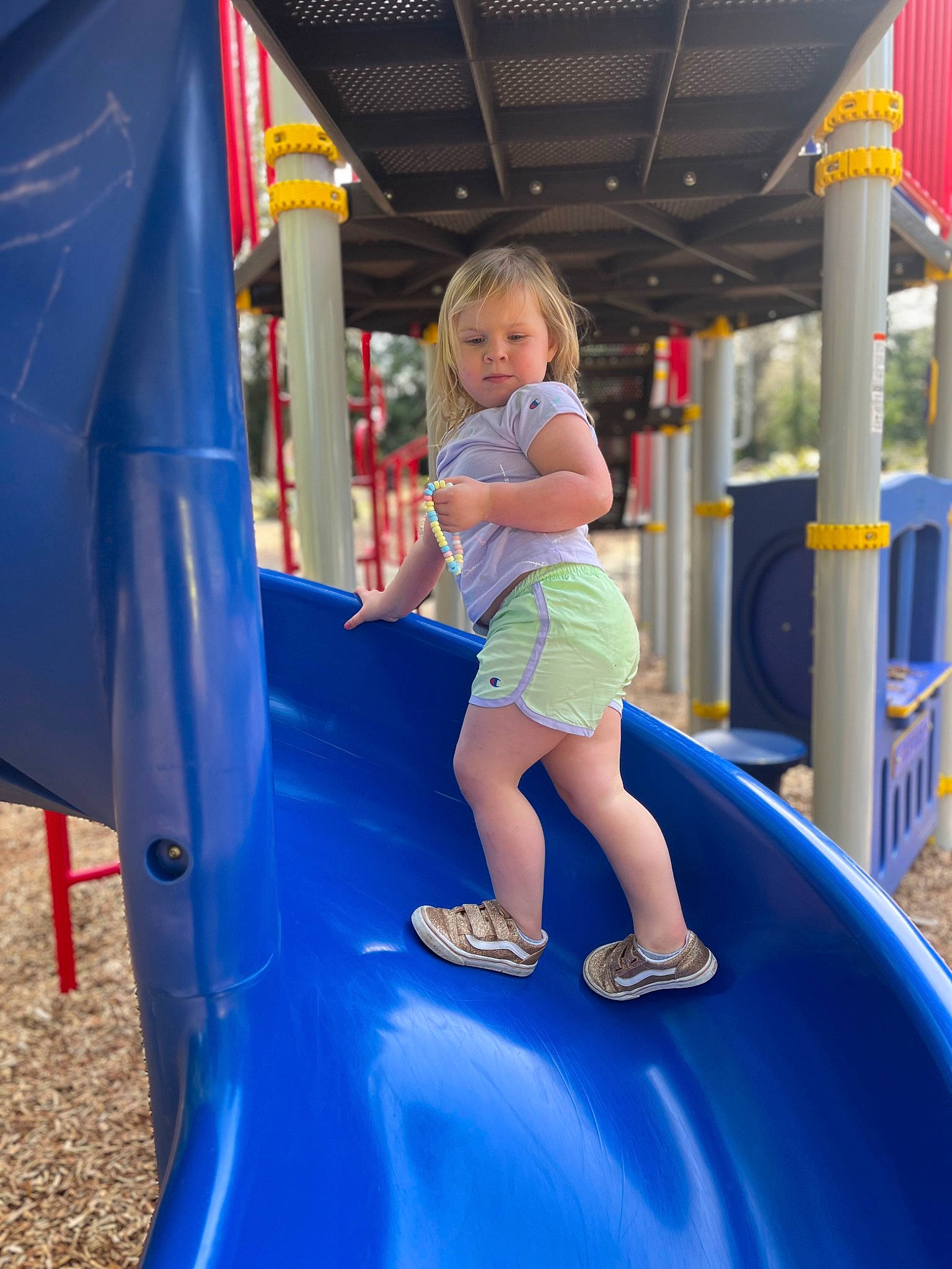 Nereida is registered to the contest to win money with this photo: blue, child, chute, city, clothing, electric_blue, fun, games, grass, inflatable, leisure, outdoor_play_equipment, person, play, playground, playground_slide, recreation, shorts, t_shirt, toddler
