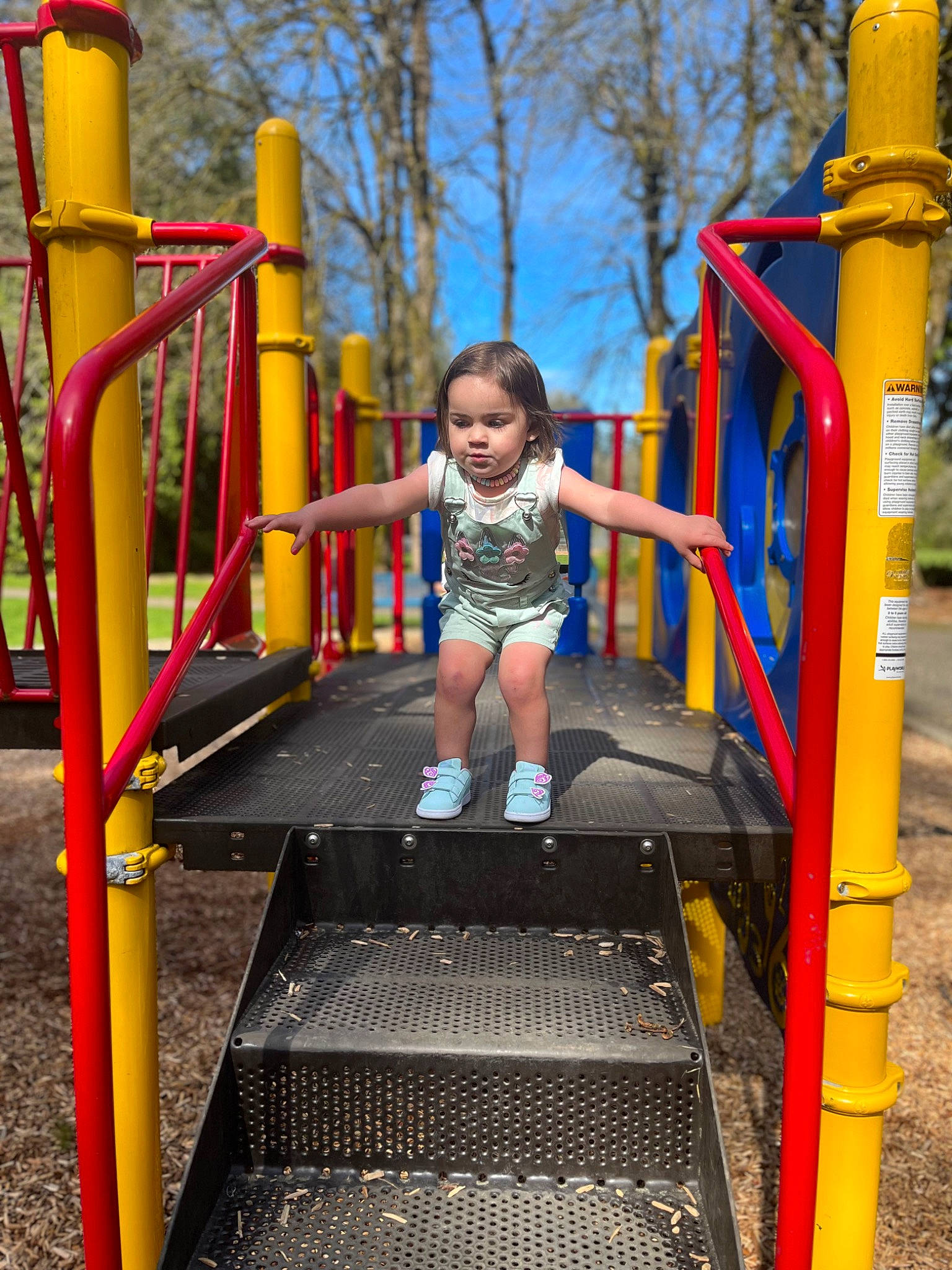 Kendal is registered to the contest to win money with this photo: baby_toddler_clothing, child, chute, city, electric_blue, fun, leisure, nonbuilding_structure, outdoor_play_equipment, person, plant, play, playground, recreation, shorts, smile, symmetry, t_shirt, toddler, tree