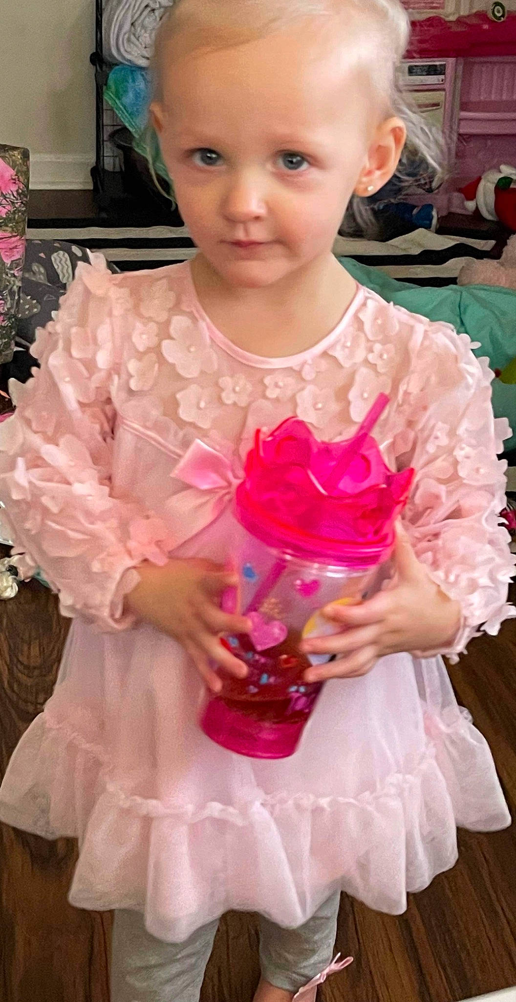 Maggie is registered to the contest to win money with this photo: baby_toddler_clothing, bridal_accessory, child, clothing, dress, embellishment, event, formal_wear, fun, gown, happy, headpiece, magenta, necklace, person, petal, pink, plant, toddler, wedding_ceremony_supply