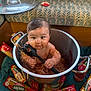 baby, child, spaghetti, pot, pasta, food, sauce, cooking_pot, kitchen, floor, package, spaghetti_package, jar, utensil, spoon, messy, cute, indoors, couch, playful