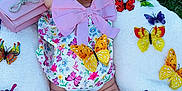 Mia joined the competition — help win amazing prizes! baby, infant, blanket, butterfly, hat, pink_bow, sunglasses, grass, outdoor, colorful, toy, foot, legs, pattern, flower, accessory, cute, soft_texture, playful, child