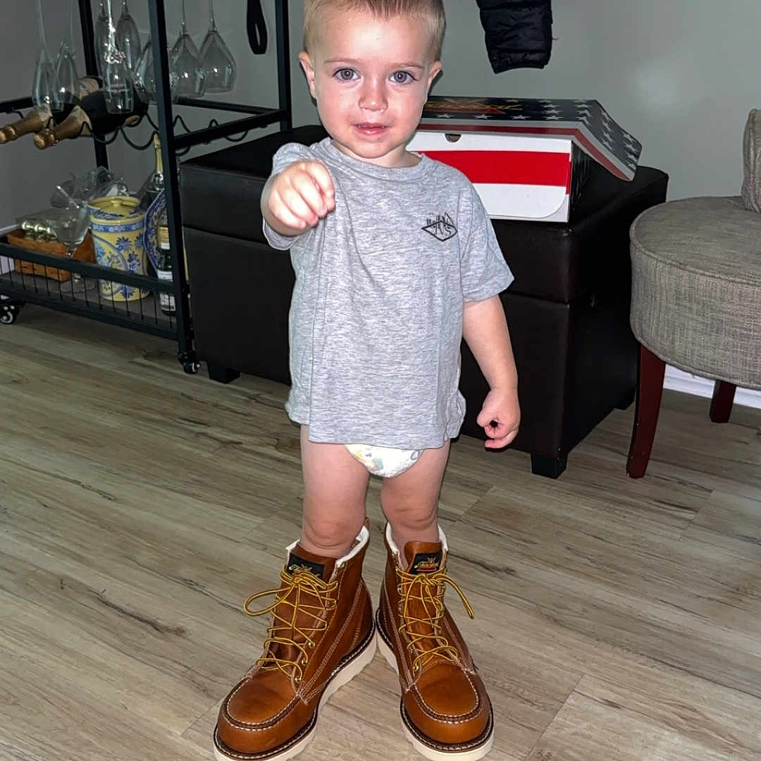 Santino is registered to the contest to win money with this photo: boy, child, clothing, face, footwear, hardwood, head, indoors, interiordesign, male, pants, person, photography, plant, portrait, pottedplant, shoe, shorts, sneaker, wood
