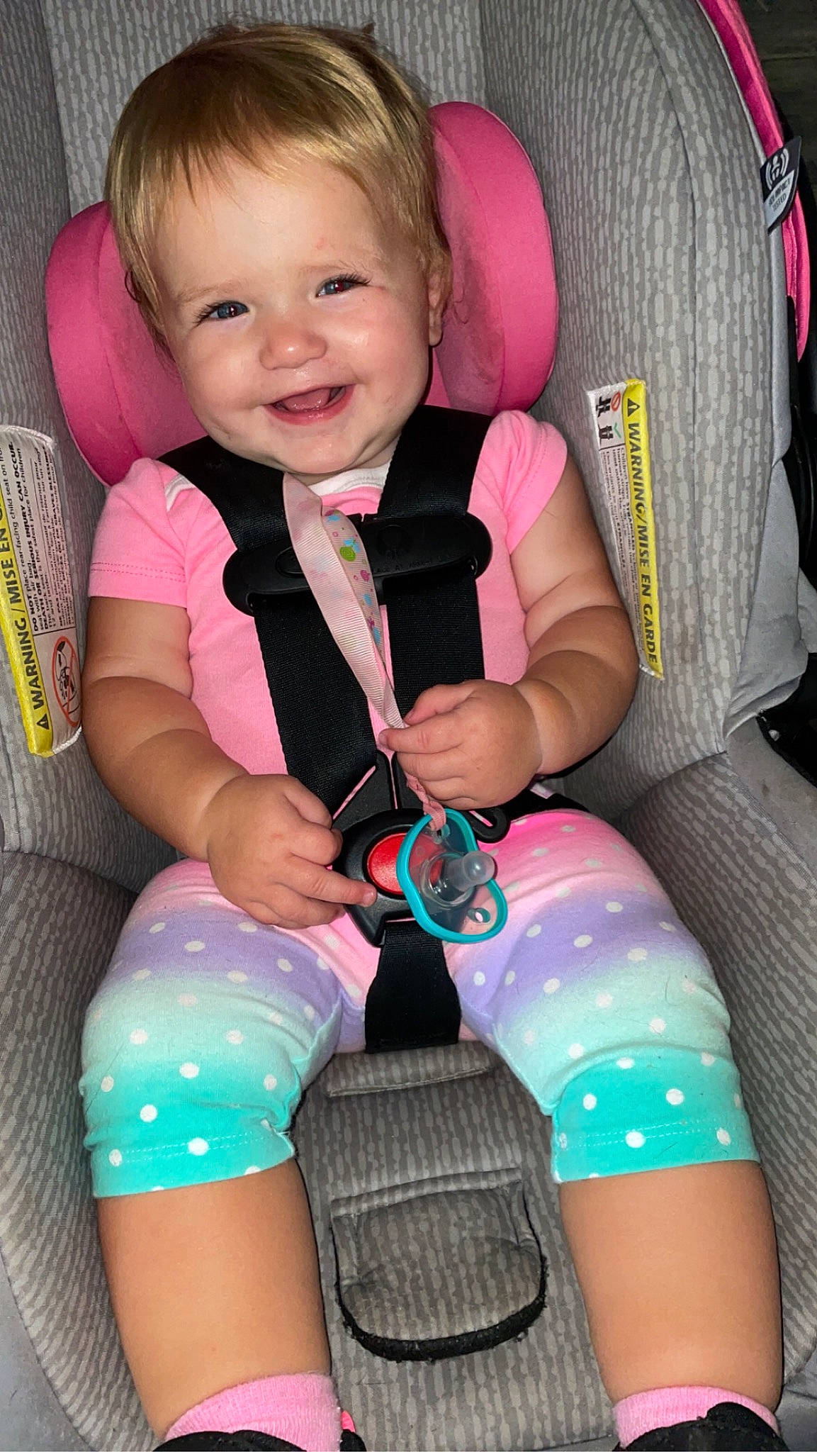 Ellie joined the competition — help win amazing prizes! baby_in_car_seat, baby_toddler_clothing, car_seat, cheek, clothing, comfort, facial_expression, finger, fun, hairstyle, happy, human, joy, leg, organ, person, pink, seat_belt, skin, smile