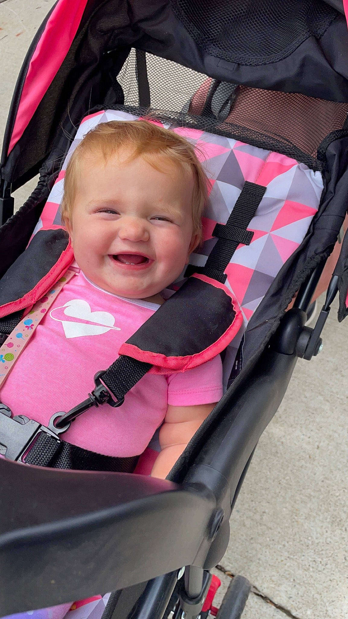 Ellie is registered to the contest to win money with this photo: auto_part, baby, baby_carriage, baby_in_car_seat, baby_products, baby_toddler_clothing, bag, car_seat, child, comfort, fun, happy, joy, lap, magenta, material_property, person, pink, sitting, skin
