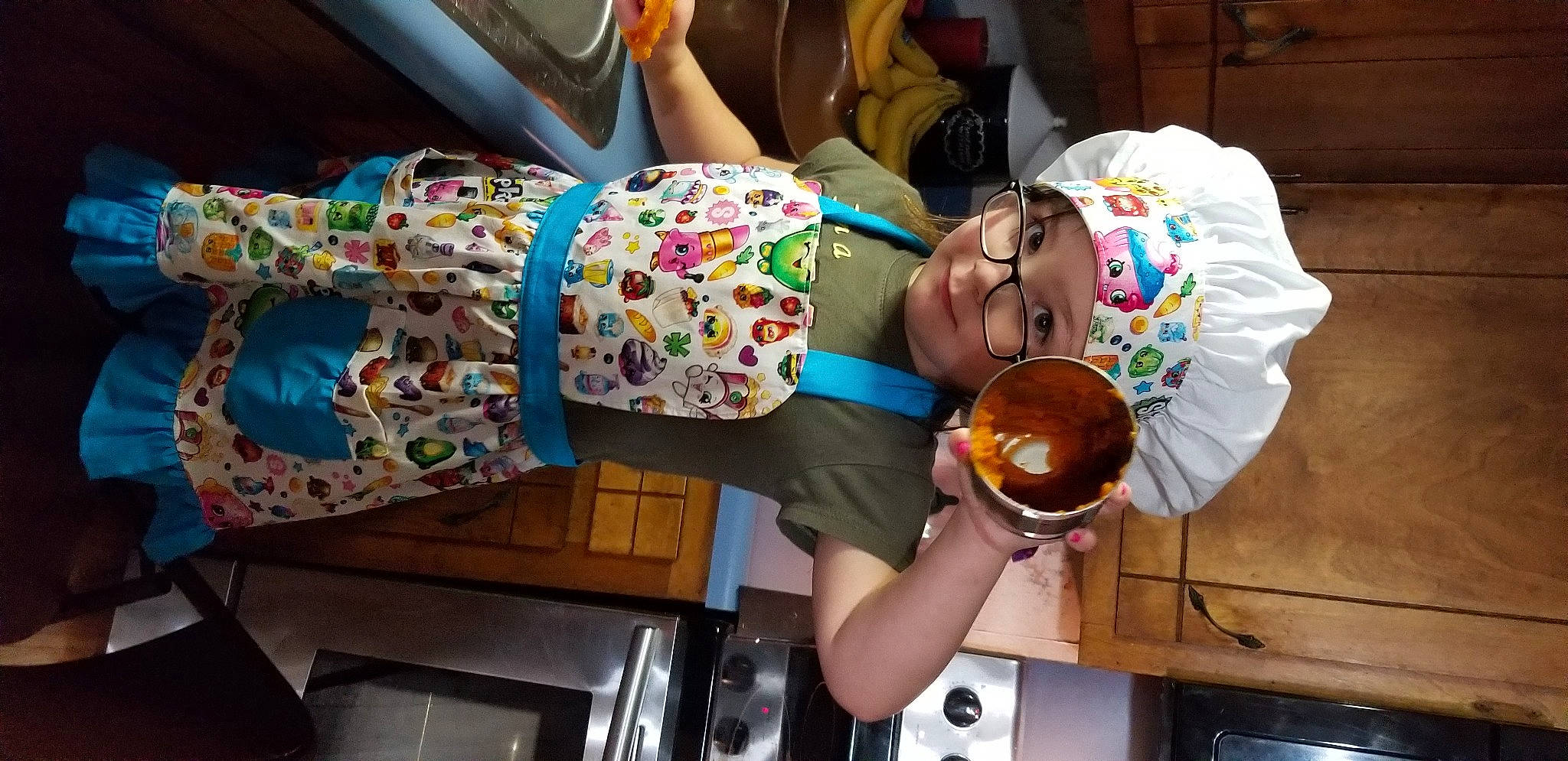 Haylee is registered to the contest to win money with this photo: baby, child, cooking, event, fast_food, food, fun, hat, headwear, party, person, room, smile, tableware, toddler