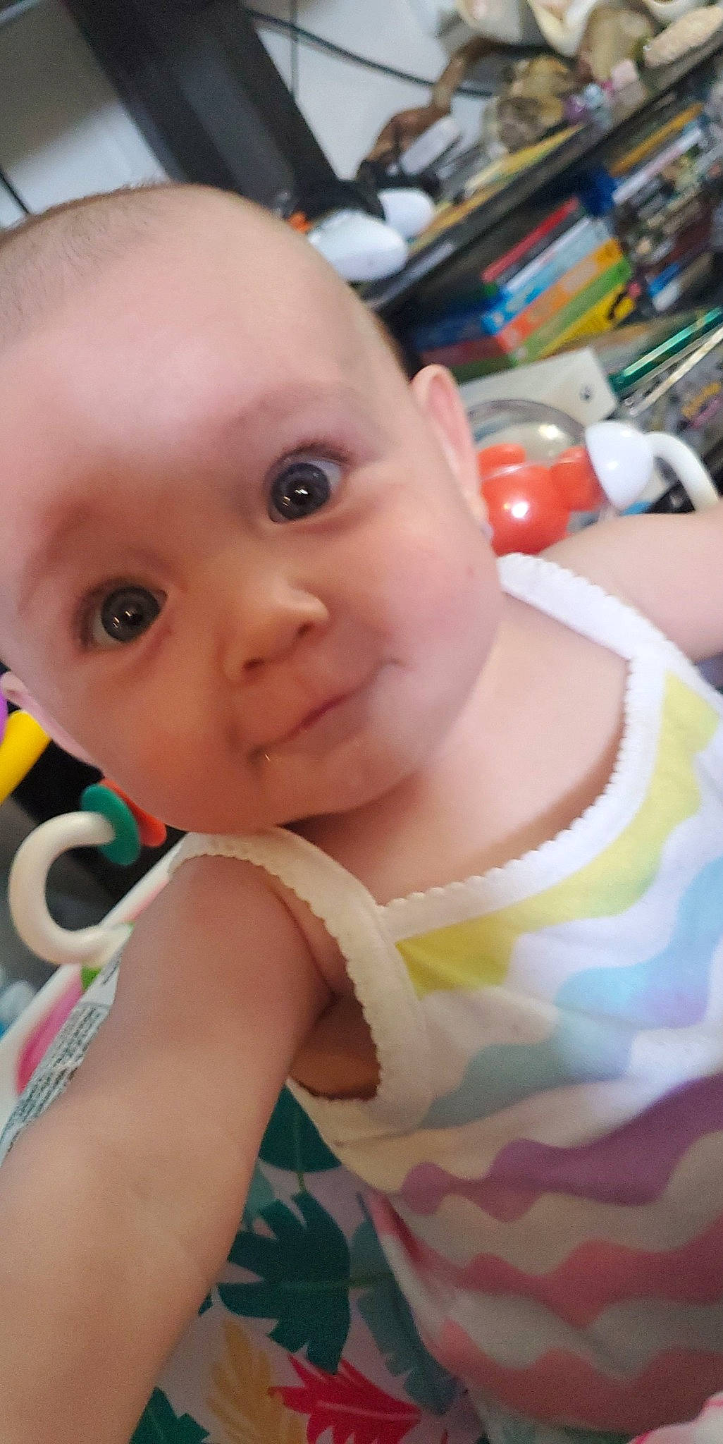 Keira joined the competition — help win amazing prizes! baby, baby_toddler_clothing, bookcase, cheek, child, chin, eye, eyebrow, eyelash, facial_expression, fun, happy, iris, lip, mouth, nose, person, shelf, skin, smile