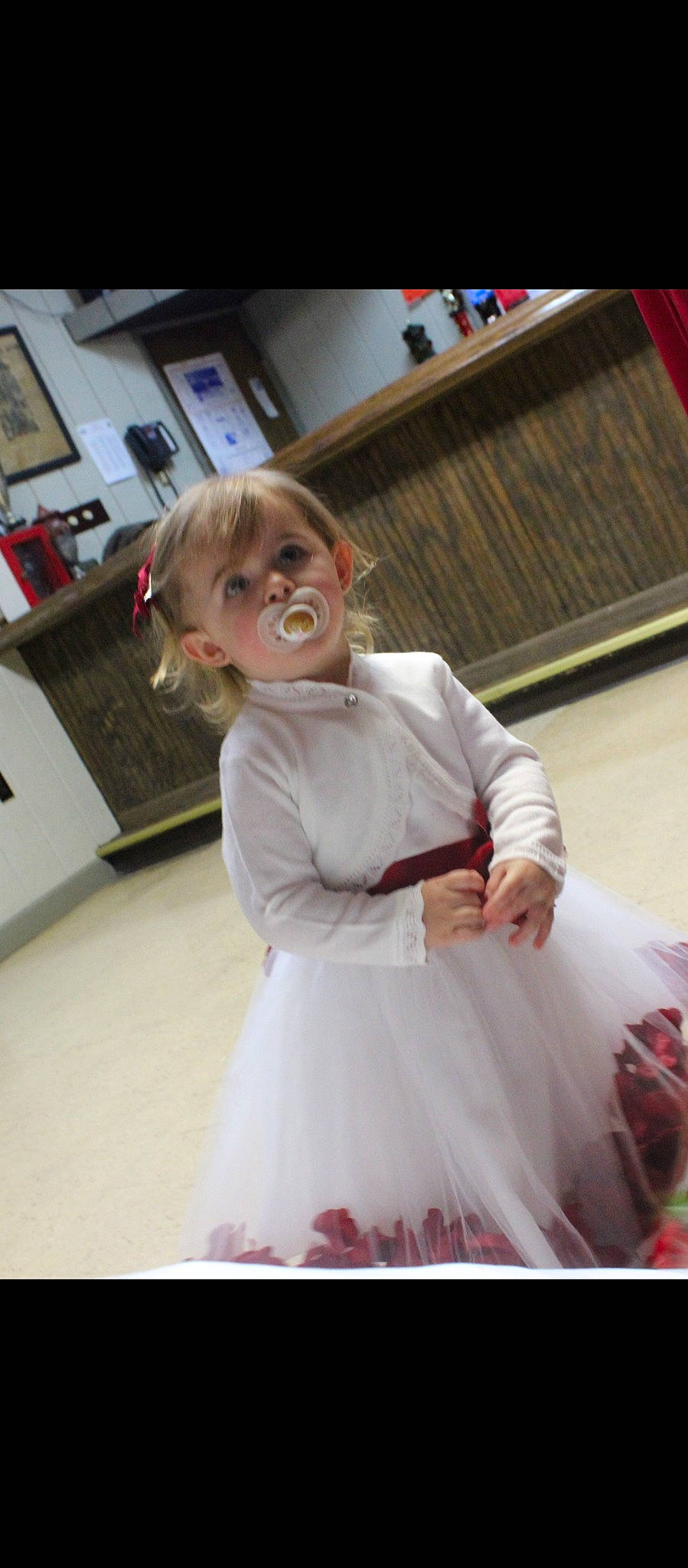 Bella is registered to the contest to win money with this photo: blond, child, dress, event, eyewear, fashion_design, flooring, formal_wear, fun, fur, glasses, happy, hime_cut, magenta, person, room, sitting, sleeve, smile, toddler