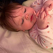 Ariel joined the competition — help win amazing prizes! baby, bed, blanket, child, closeup, curious, cute, face, fingers, hair, hand, indoor, infant, lying_down, onesie, person, pink_clothing, skin, sleepwear, soft_lighting