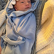 Alexander joined the competition — help win amazing prizes! baby, blanket, blue, child, face, hood, infant, quilt, soft, swaddle, toddler, wrapped, young_child, indoor, cute, sleepwear, warm, resting, newborn, comfort