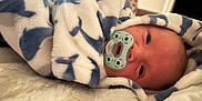 Alexander is registered to the contest to win money with this photo: baby, blanket, pacifier, infant, sleepy, soft_texture, cozy, wrapped, face, head, comfort, indoor, closeup, person, newborn, warm, resting, cute, patterned_blanket, lying_down