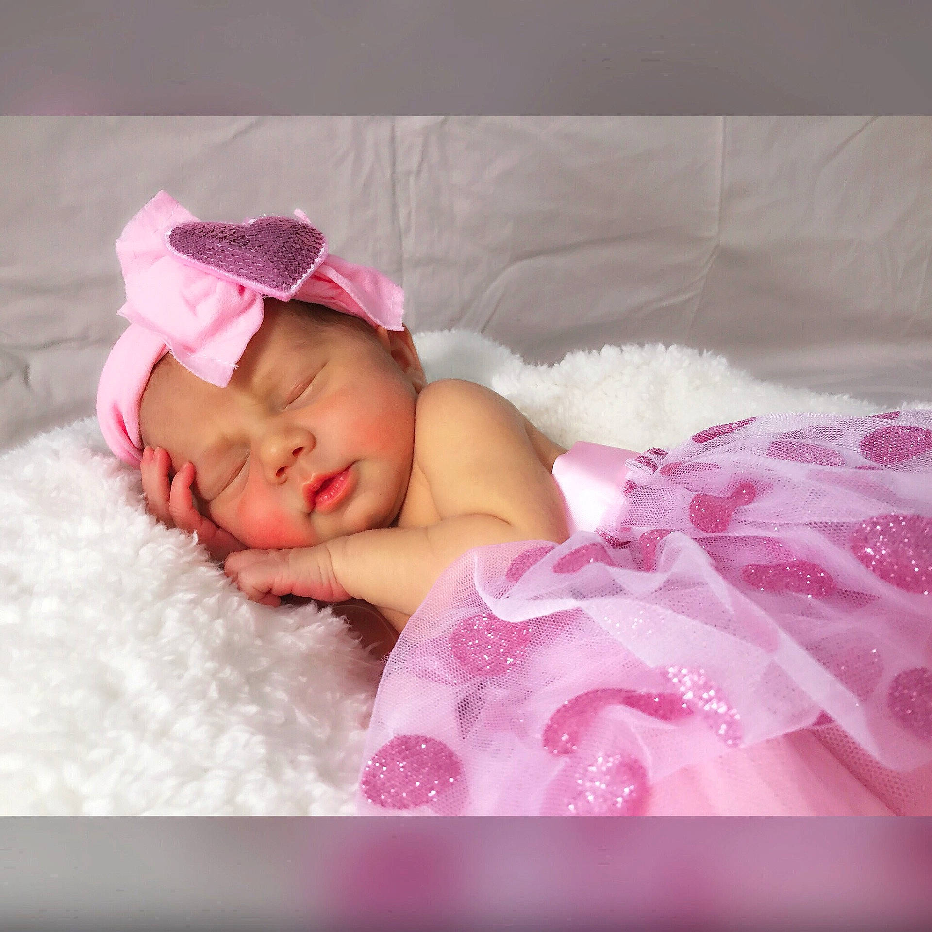 Estelle is registered to the contest to win money with this photo: beauty, child, girl, hair_accessory, headwear, infant, person, petal, pink, product, skin, sleep, textile, toddler