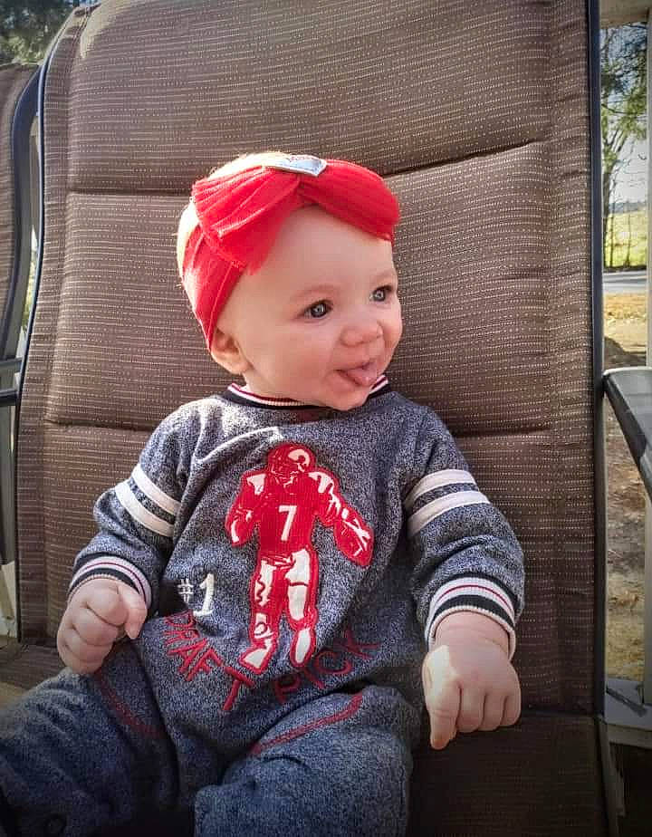 Ellis is registered to the contest to win money with this photo: baby, baby_toddler_clothing, cap, child, chin, costume_hat, eye, facial_expression, grass, hairstyle, hat, head, headgear, headwear, lip, person, plant, skin, sleeve, smile