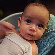 Sterling is registered to the contest to win money with this photo: baby, infant, face, eyes, towel, blanket, skin, expression, curious, closeup, portrait, child, young, head, person, resting, indoors, soft, texture, sleepwear