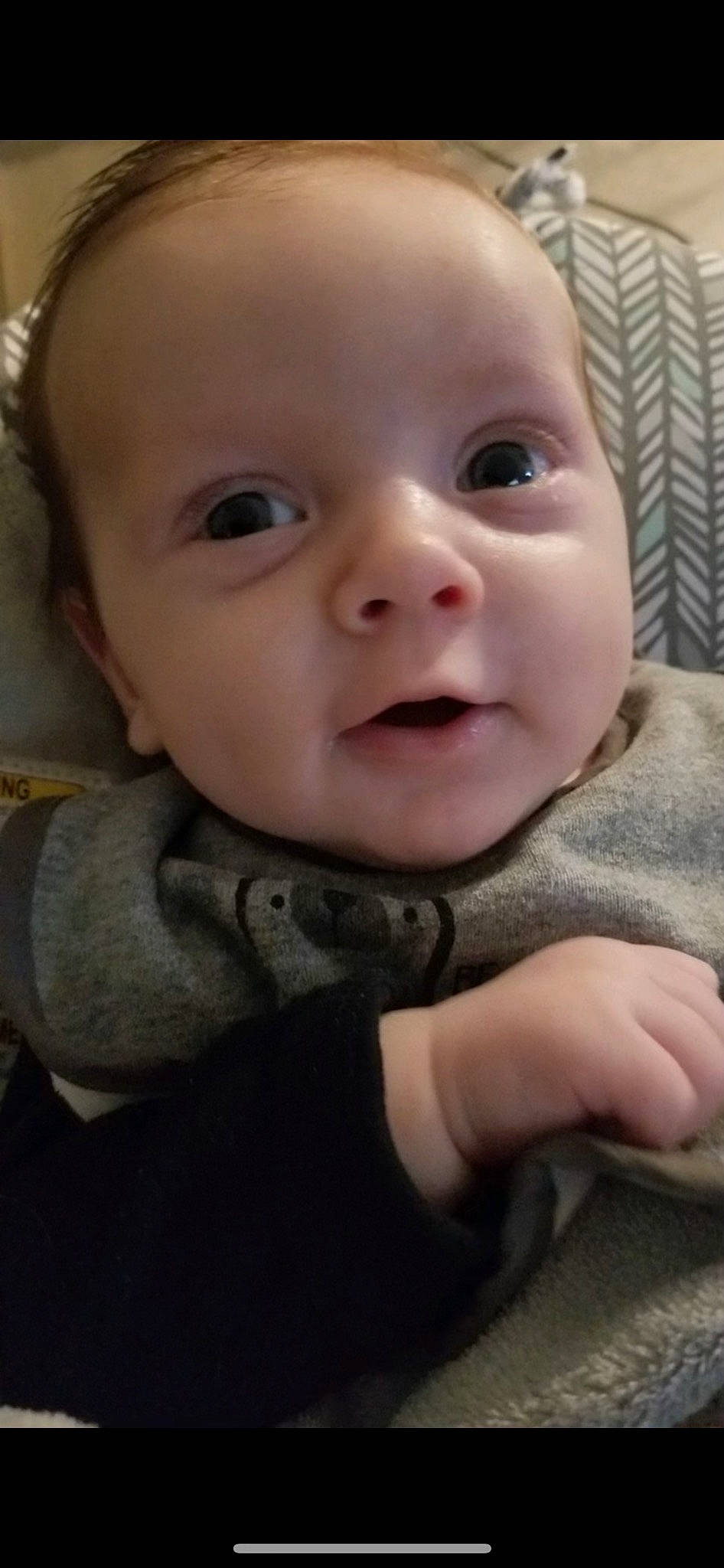 Holden is registered to the contest to win money with this photo: baby, baby_toddler_clothing, cheek, child, collar, eyelash, grass, grey, happy, iris, lip, nose, outerwear, pattern, person, sitting, skin, sleeve, smile, thumb