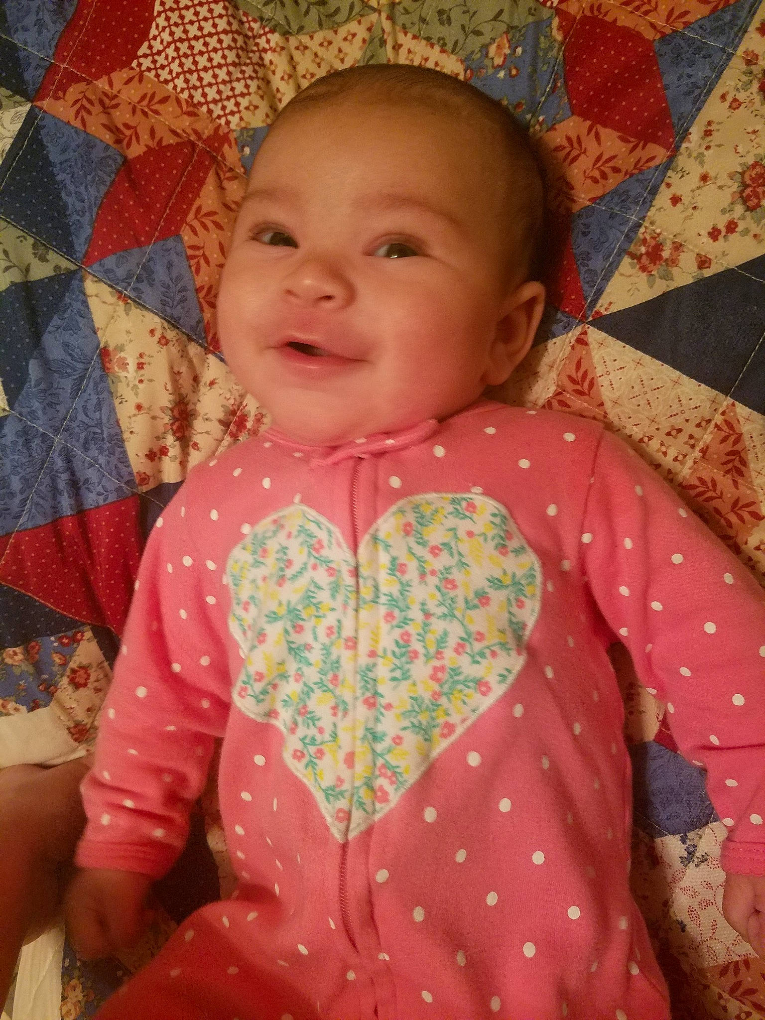 Flora is registered to the contest to win money with this photo: cheek, child, day, design, dress, eye, facial_expression, girl, head, infant, iris, nose, pattern, person, pink, plaid, product, skin, smile, textile