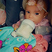 Mya joined the competition — help win amazing prizes! baby, bottle, blanket, bow, car_seat, child, clothing, cute, drinking, face, headband, infant, indoors, person, pink, portrait, seatbelt, soft_toys, toddler, warm