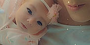 Mya is registered to the contest to win money with this photo: baby, woman, face, portrait, closeup, holding, pink, headband, star_effects, soft_lighting, tender, cozy, expressive_eyes, clothing, indoor, person, cute, infant, mother, affection