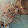 baby, woman, face, portrait, closeup, holding, pink, headband, star_effects, soft_lighting, tender, cozy, expressive_eyes, clothing, indoor, person, cute, infant, mother, affection