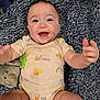 baby, smiling, infant, blanket, plush_toy, elephant, happy, cute, clothing, onesie, indoor, child, person, face, portrait, skin, head, arms, legs, toddler