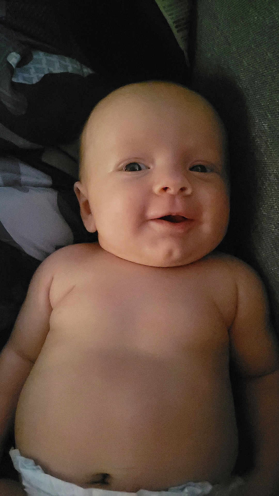 Iris joined the competition — help win amazing prizes! baby, infant, face, skin, smile, diaper, lying_down, chubby, cute, child, human, portrait, expression, indoors, head, torso, person, newborn, soft_lighting, closeup