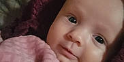 Iris joined the competition — help win amazing prizes! baby, child, infant, blanket, pink, face, skin, hand, portrait, closeup, expression, young, cozy, soft, cute, curious, indoors, person, comfort, resting
