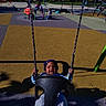 Keyon joined the competition — help win amazing prizes! baby, child, infant, swing, playground, outdoor, park, smiling, happy, sitting, play_equipment, chains, playground_surface, sunlight, shadow, blue_sky, trees, family, daytime, portrait