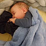 Ethan a rejoint le concours — aidez-le/la à gagner de superbes lots ! baby, sleeping, blanket, blue_blanket, hand, face, head, crib, cushion, braided_cushion, infant, clothing, cozy, resting, soft_texture, indoor, child, peaceful, person, toddler