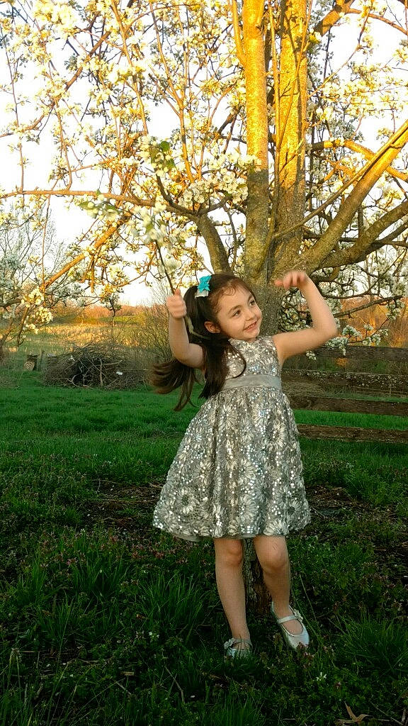 Kailey is registered to the contest to win money with this photo: branch, dress, fawn, fun, gesture, grass, happy, joy, long_hair, people_in_nature, person, photo_shoot, photography, plant, smile, spring, sunlight, tree