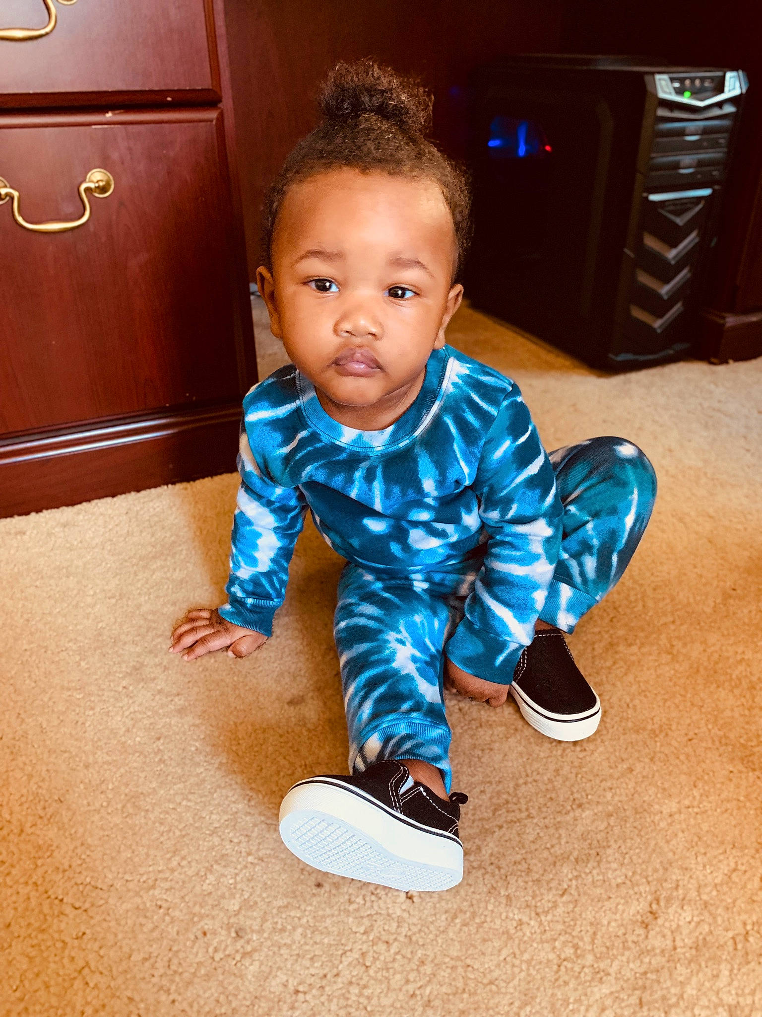 Antonio is registered to the contest to win money with this photo: baby_toddler_clothing, cabinetry, cool, drawer, eye, face, floor, flooring, footwear, hair, happy, hardwood, head, mammal, person, shoe, sleeve, sneakers, standing, toddler