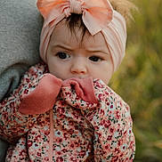 Thea joined the competition — help win amazing prizes! baby, child, headband, bow, floral, mittens, outdoor, nature, person, portrait, cute, expression, clothing, hand, face, young, soft_light, warm_colors, holding, infant