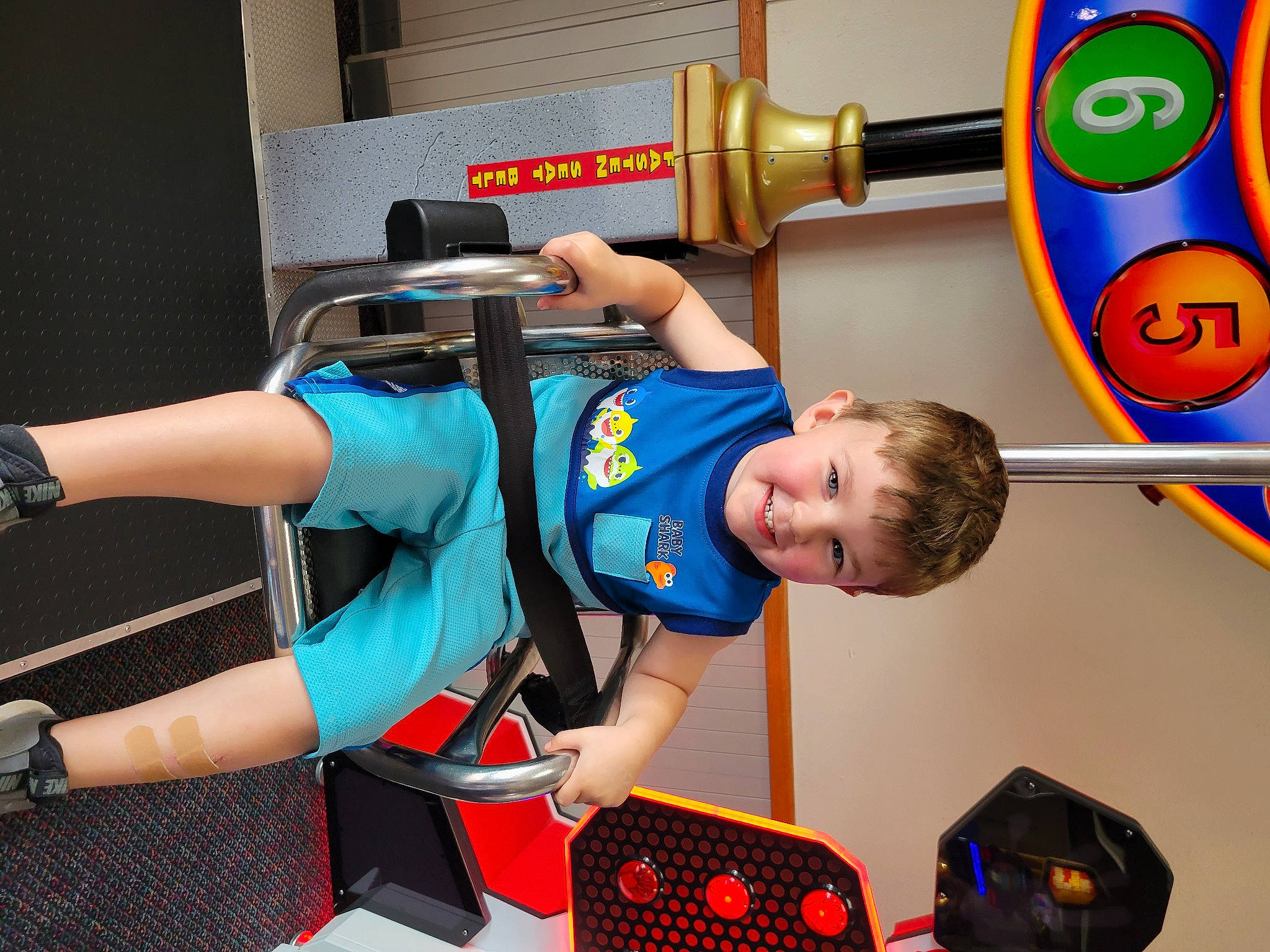 Easton is registered to the contest to win money with this photo: baby, child, elbow, electric_blue, engineering, fun, human_leg, joy, leisure, machine, metal, person, play, recreation, room, shorts, sportswear, t_shirt, toddler, watch