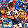Axell is registered to the contest to win money with this photo: balloons, birthday, cake, cartoon_characters, celebration, child, colorful, costume, family_event, figurine, gift, indoors, number_two, paw_patrol, paw_prints, portrait, sitting, smiling_characters, toddler, toy