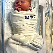 Jeremiah is registered to the contest to win money with this photo: newborn, baby, infant, sleeping, swaddled, hospital, bassinet, blanket,  의료, portrait, face, hands, closed_eyes, peaceful, indoors, medical_setting, newborn_care, white_blanket, hospital_bassinet, photograph