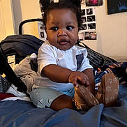 Marquele joined the competition — help win amazing prizes! baby, child, indoor, bed, blanket, clothing, footwear, person, portrait, hair, cute, infant, room, photography, furniture, wall_photos, expression, sitting, hand, shoe