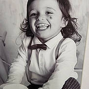 Miguel-Marco participe au concours pour gagner de l'argent avec cette photo : toddler, child, smile, bow_tie, suspenders, toy, black_and_white, portrait, happy, curly_hair, face, clothing, long_sleeve, cute, indoors, playful, person, young_child, joyful, classic