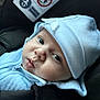 baby, infant, face, hat, blue_clothing, car_seat, seatbelt, straps, closeup, child, cute, apparel, headwear, young_child, safety, indoors, portrait, soft_light, expression, newborn