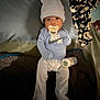 baby, baby_clothes, bed, blanket, bottle, child, clothing, comfort, cute, hat, indoors, infant, lying_down, nursery, pacifier, pillow, resting, sleepwear, soft_lighting, young_child