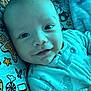 Leo joined the competition — help win amazing prizes! baby, blanket, child, christmas, closeup, cozy, cute, face, happy, head, holiday, indoors, infant, lying_down, pajamas, pattern, person, sleepwear, smile, soft_lighting