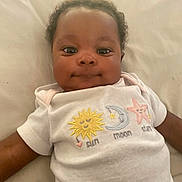 Jazorah is registered to the contest to win money with this photo: baby, infant, onesie, smiling, face, child, cute, laying, white, clothing, sun, moon, star, soft, bed, portrait, happy, young, human, sleepwear