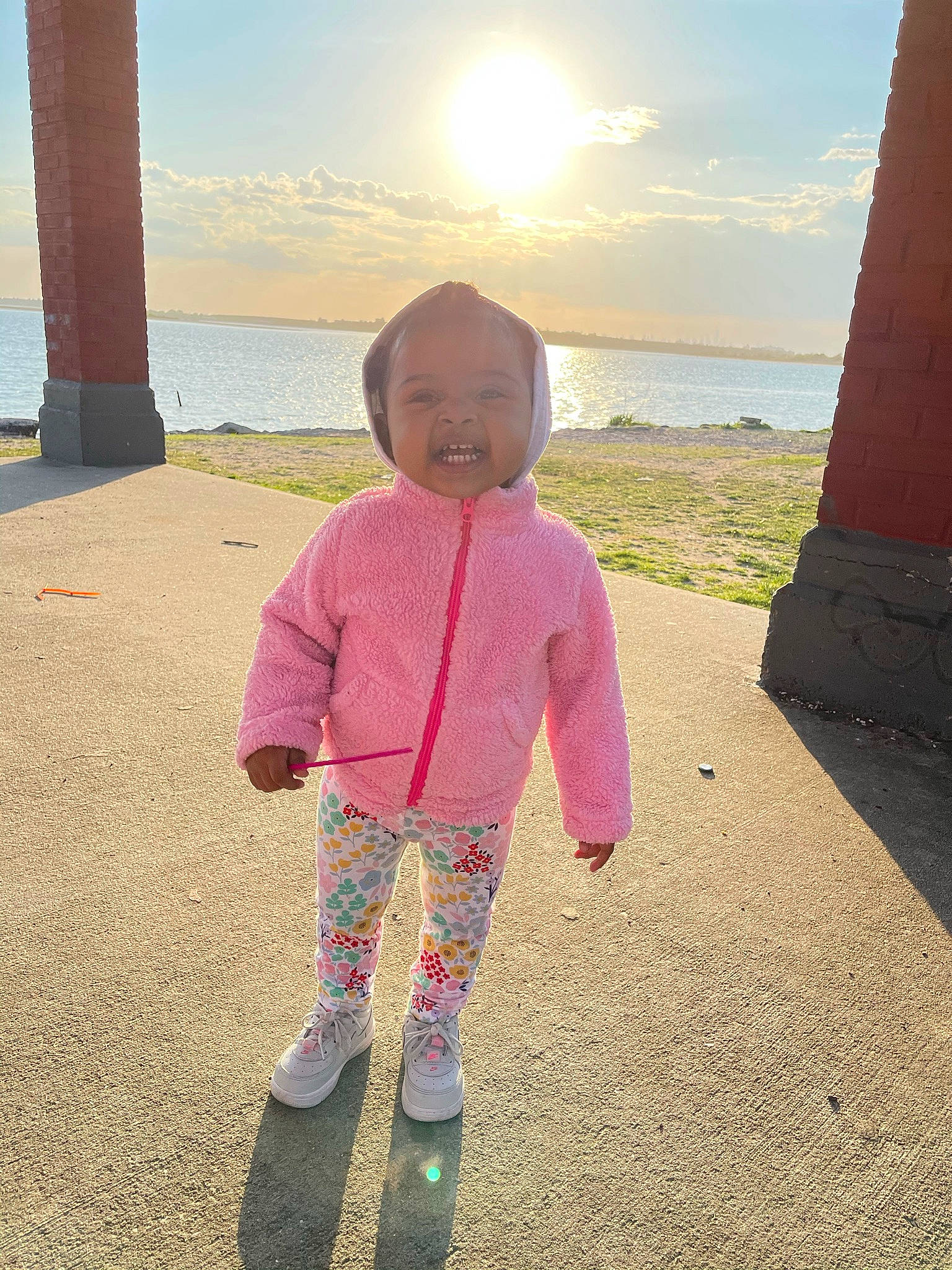 Maleah joined the competition — help win amazing prizes! asphalt, baby_toddler_clothing, body_of_water, eye, fun, grass, happy, horizon, light, morning, people_in_nature, person, sand, sky, standing, summer, sunlight, tints_and_shades, toddler, travel