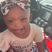 Serenity joined the competition — help win amazing prizes! baby, child, infant, smiling, happy, portrait, car, car_interior, car_seat, headband, bow, clothing, dress, pink, patterned, sitting, face, eyes, indoors, daylight
